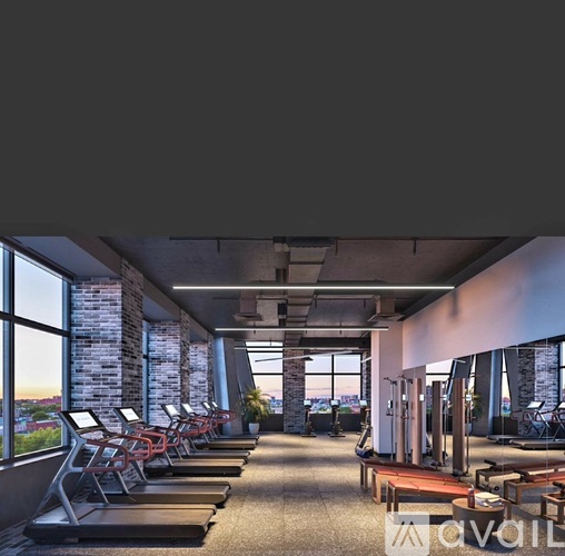A gym with treadmills and a view of the city.