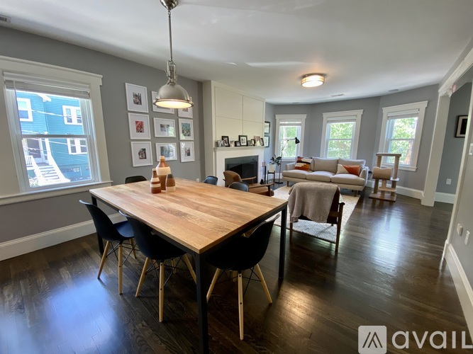 A dining room with a wooden table and chairs.