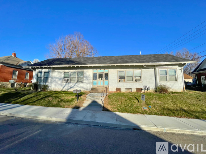 A house with a blue door is for sale.