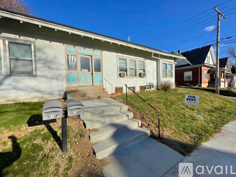 A house with a "For Rent" sign in front of it.