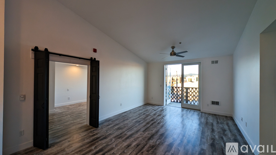 A room with wooden flooring and a ceiling fan.