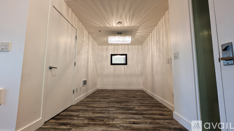 A long hallway with a television mounted on the wall.