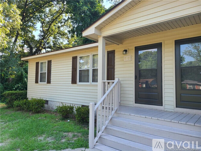 A house with a front porch and a white railing.