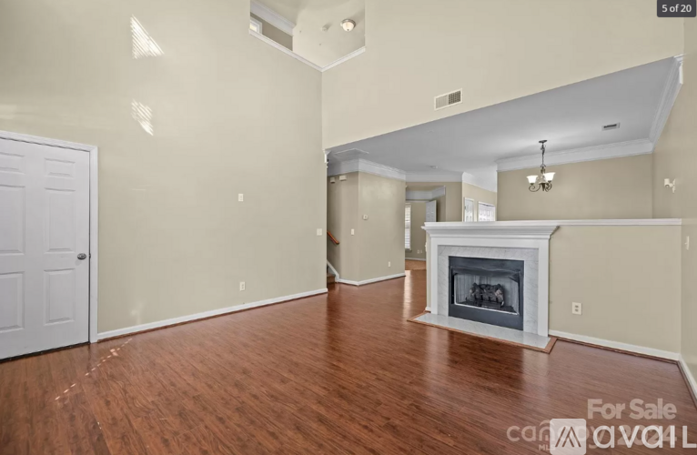 A room with a fireplace and a door on the left side.