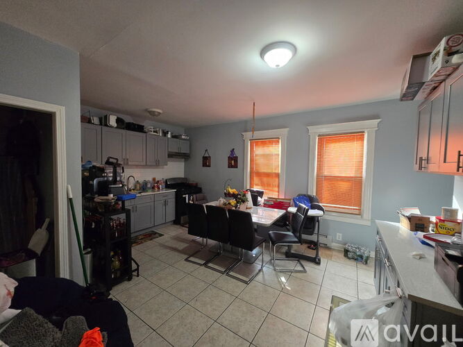 A kitchen with a table and chairs in the middle of the room.