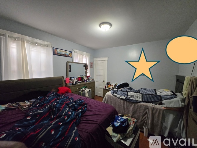 A bedroom with two beds and a dresser with a mirror.