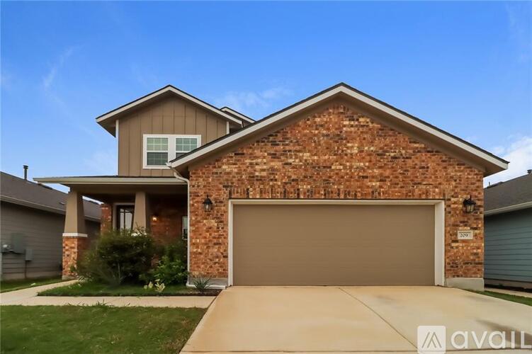 A house with a garage door and a driveway.