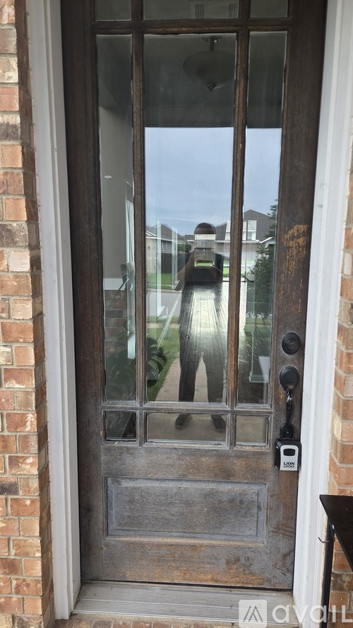 A wooden door with a glass window above it.
