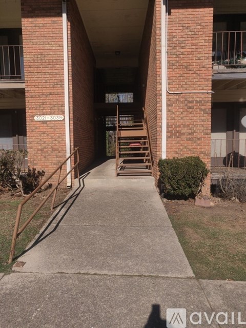 A long hallway with a staircase leading to the second floor.
