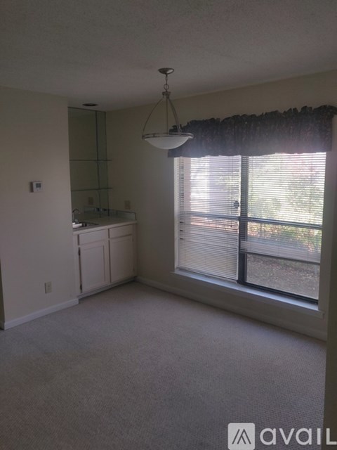 A room with a window and a cabinet.