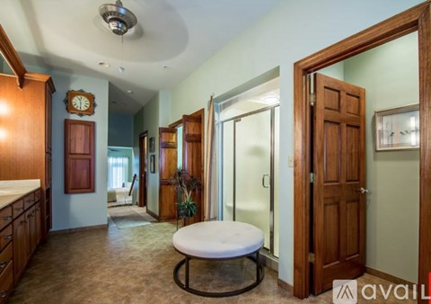 A living room with a couch and a wooden door.