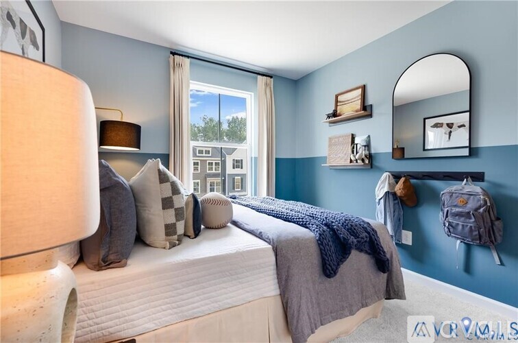 A bedroom with a large bed and a window overlooking a cityscape.