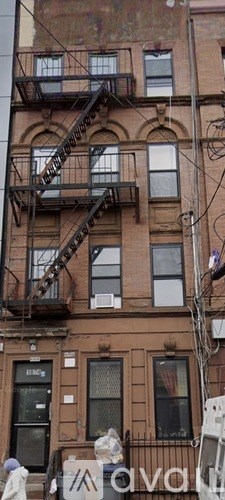 A brown building with a fire escape.