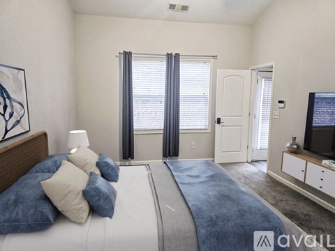 A bedroom with a large bed and a television in the corner.