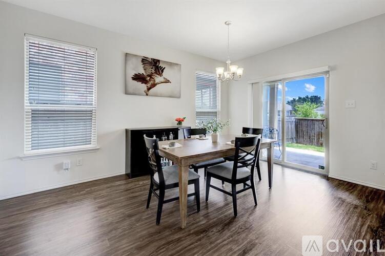 A dining room with a wooden table and chairs.
