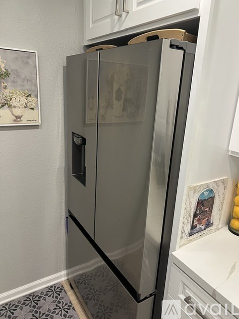A stainless steel refrigerator in a kitchen.