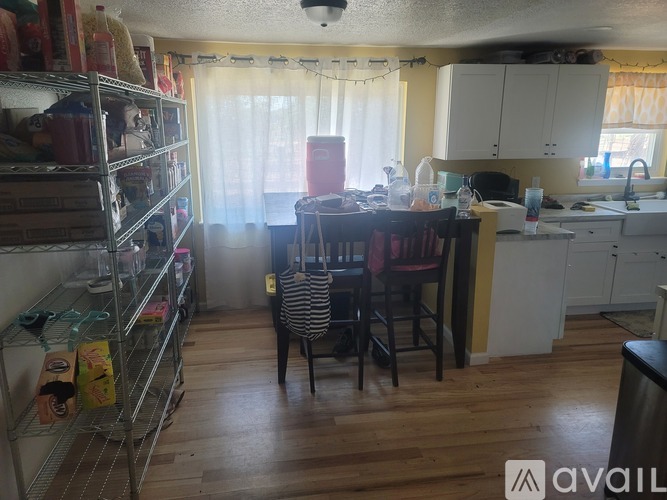 A kitchen with a table and chairs in the middle of the room.