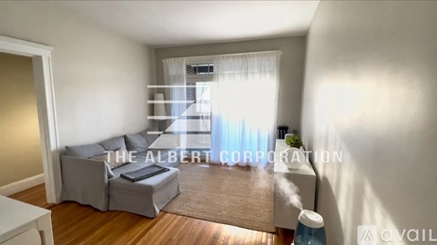 A living room with a grey sofa and a small table.