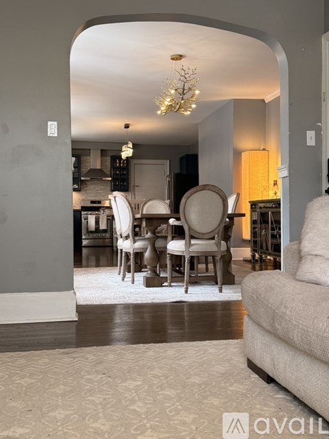 A living room with a dining table and chairs.