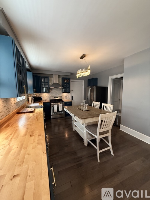 A kitchen with a dining table and chairs.