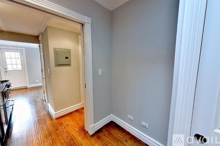 A room with a white door and a window.
