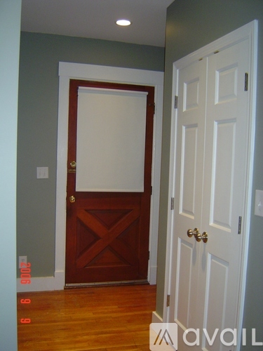 A white door is to the right of a brown door.