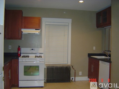 A kitchen with a white stove and a white oven.