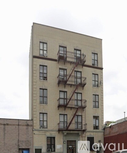 A tall building with a fire escape on the side.