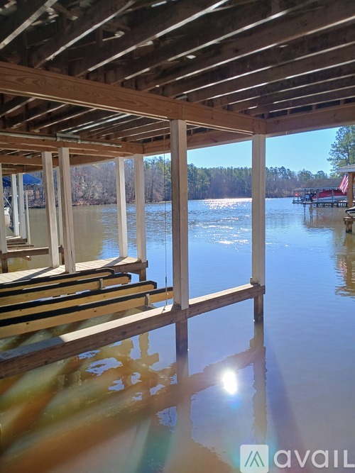 A wooden structure is surrounded by flood water.