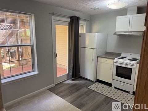 A kitchen with a white refrigerator and stove.
