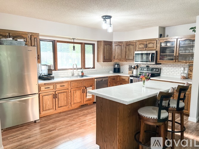 A kitchen with wooden cabinets and a white countertop.