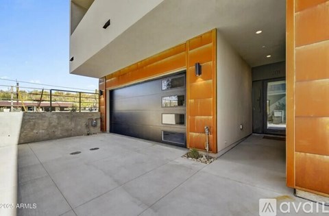 A modern house with a garage door and a driveway.