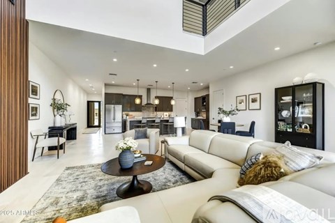 A modern living room with a large white sofa and a coffee table.