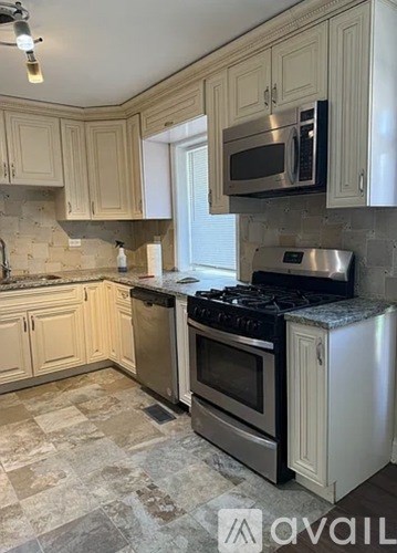 A kitchen with a stove top oven and a microwave above it.