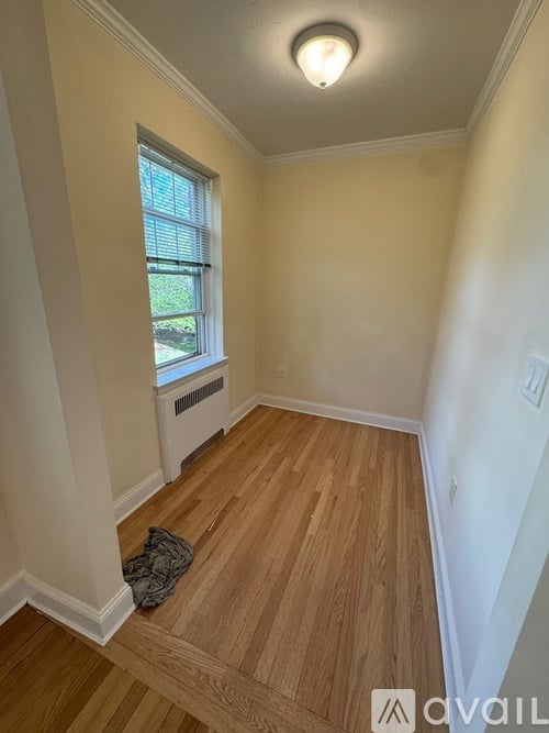 A room with a window and a radiator on the wall.