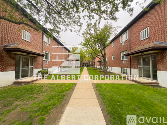 A brick building with the words "The Albert Corporation" written on it.