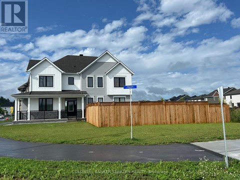 A house with a blue sign in front of it.
