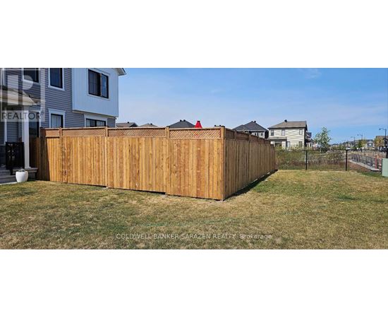 A wooden fence in front of a house.