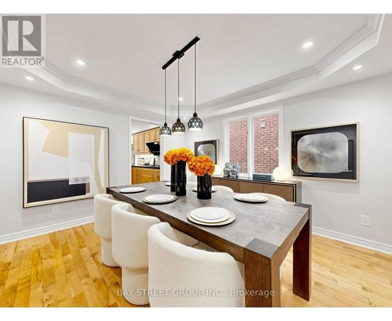 A dining room with a wooden table and chairs.