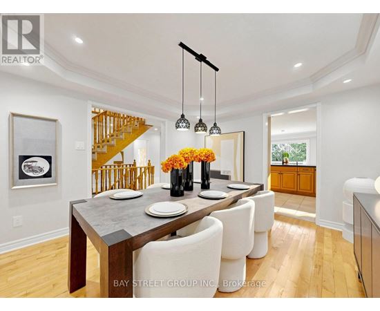 A dining room with a wooden table and chairs.