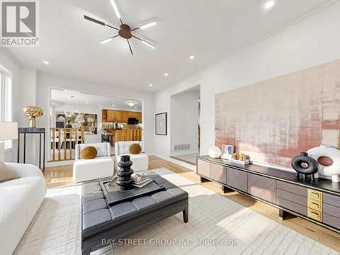 A living room with a black coffee table and a ceiling fan.