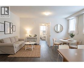 A living room with a couch, a coffee table, and a dining table.