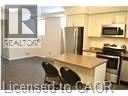 A kitchen with a counter and a refrigerator.