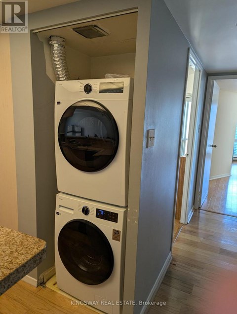 A washer and dryer stacked on top of each other in a laundry room.