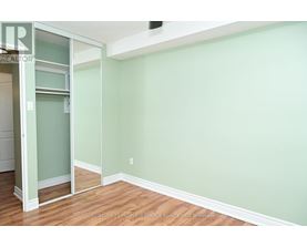 A room with a green wall and wooden floor.