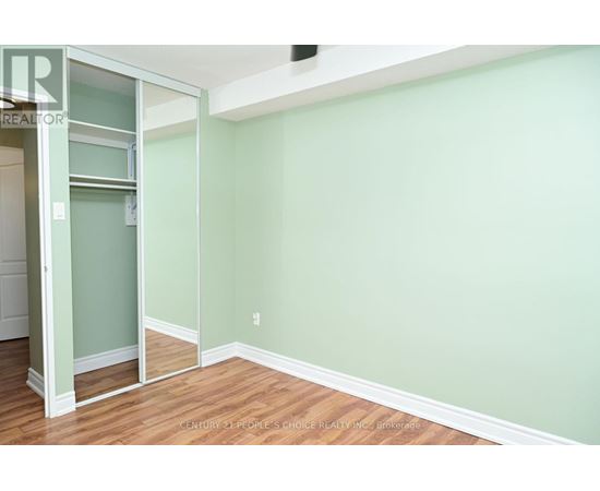 A room with a green wall and wooden floor.