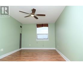 A room with a ceiling fan and a window.