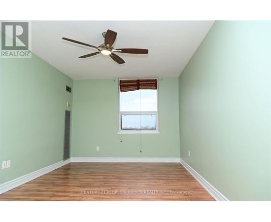 A room with a ceiling fan and a window.