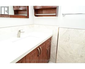 A bathroom with a sink and a mirror.