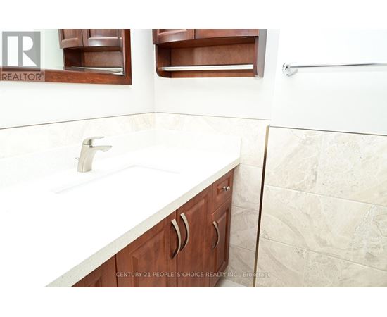 A bathroom with a sink and a mirror.